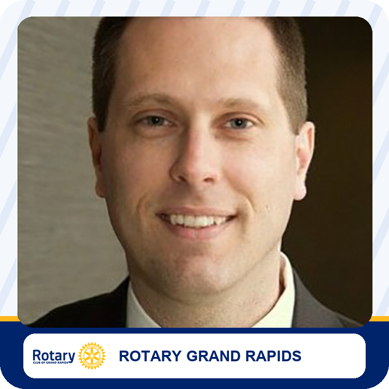 robh-foundation-leadership Smiling man in a suit, head-and-shoulders portrait for Rotary Grand Rapids branding
