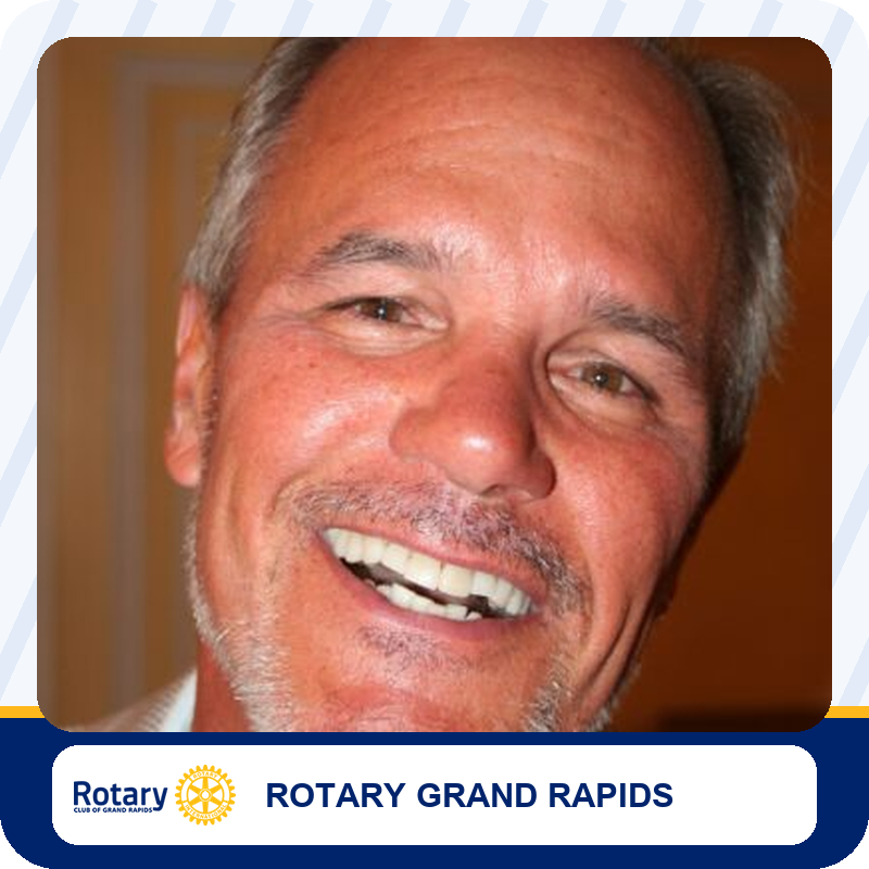 tom-bylenga Close-up portrait of a smiling middle-aged man with gray hair, used for Rotary Grand Rapids.